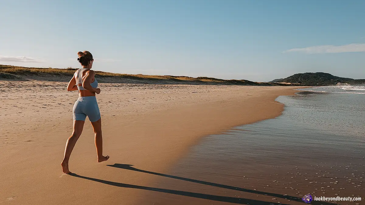 Woman jogging on beach for heart-healthy morning habits